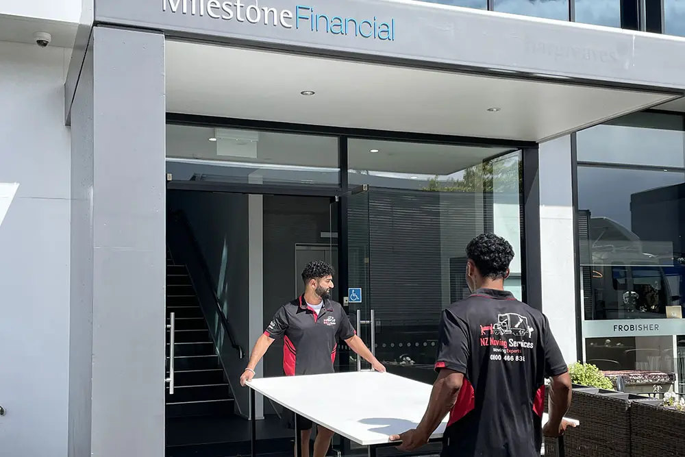 Christchurch's affordable office movers carrying desks into new premises