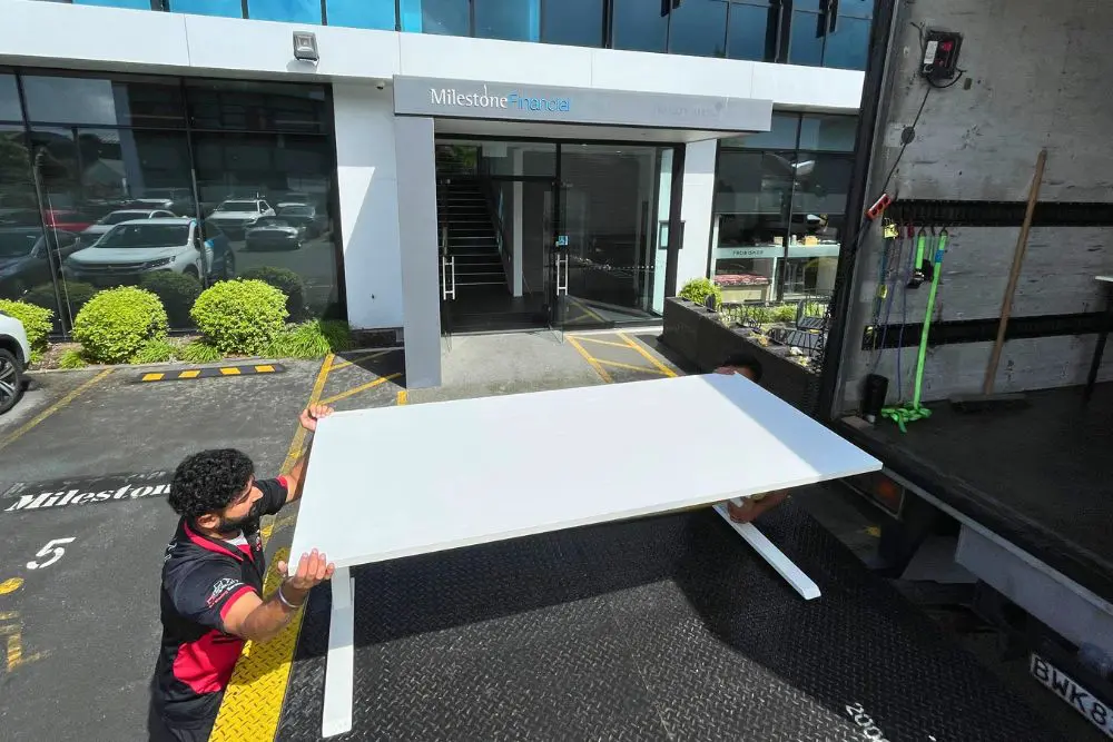 Professional movers safely packing the truck